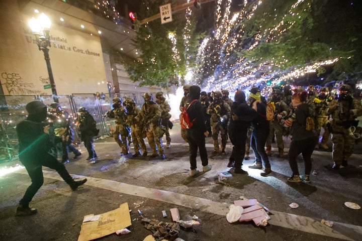 Federal officers advance on demonstrators during a Black Lives Matter protest at the Mark O. Hatfield United States Courthous