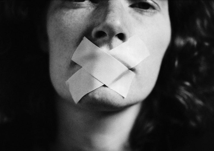 Gagged woman, close-up, blurred