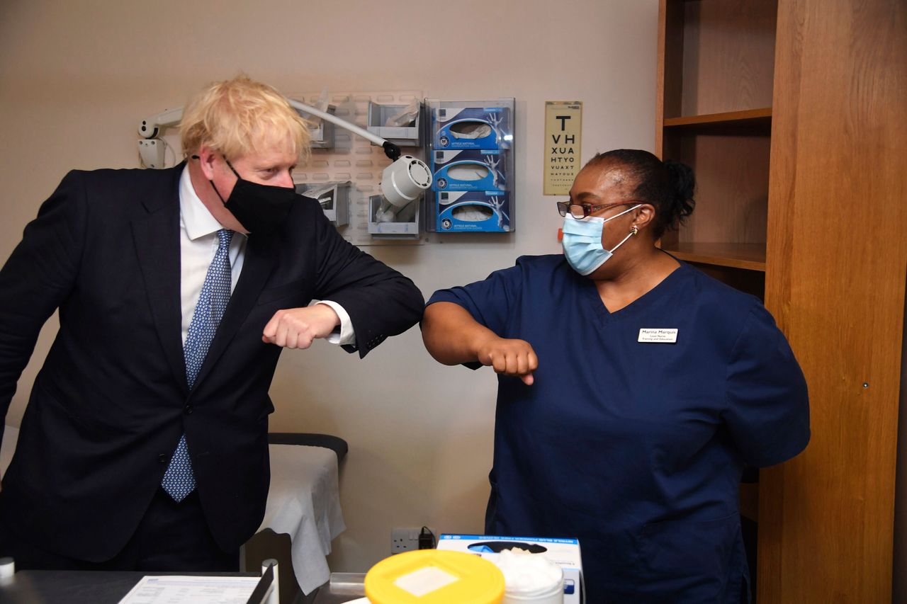 Boris Johnson elbow bumps Lead Nurse Marina Marquis, during a visit to Tollgate Medical Centre in Beckton, East London