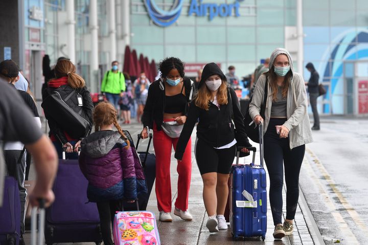 Passengers arriving at Birmingham Airport, as people arriving into England from holidays in Spain have been told they must quarantine when they return home.