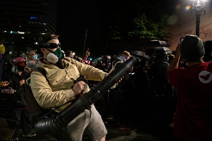 A protester uses a leaf blower to direct tear gas back towards the federal police n front of the Mark O. Hatfield U.S. Courthouse during protests on July 25, 2020 in Portland, Oregon.