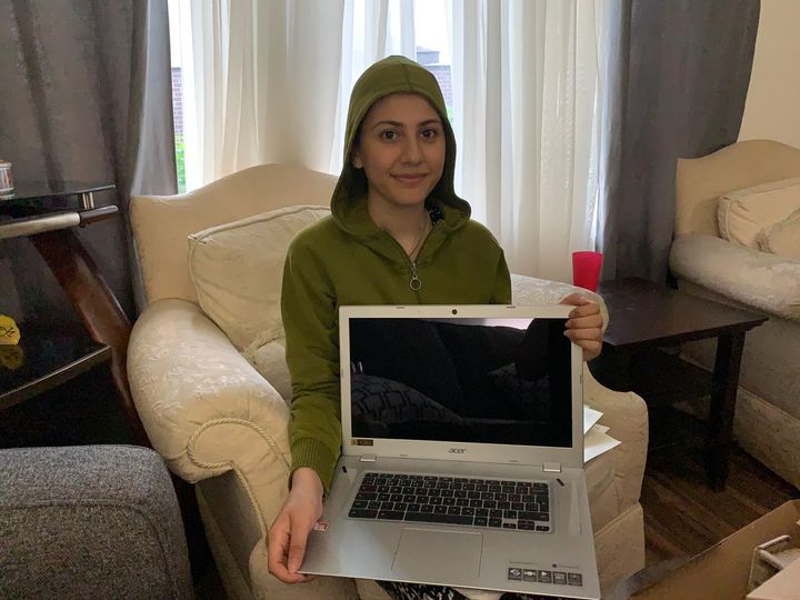 Aya Abou Rshd poses with her new laptop.