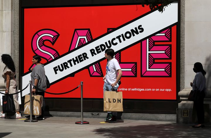 People queue to enter into a Selfridges store amid the coronavirus disease (Covid-19) outbreak, at Oxford Street in London.