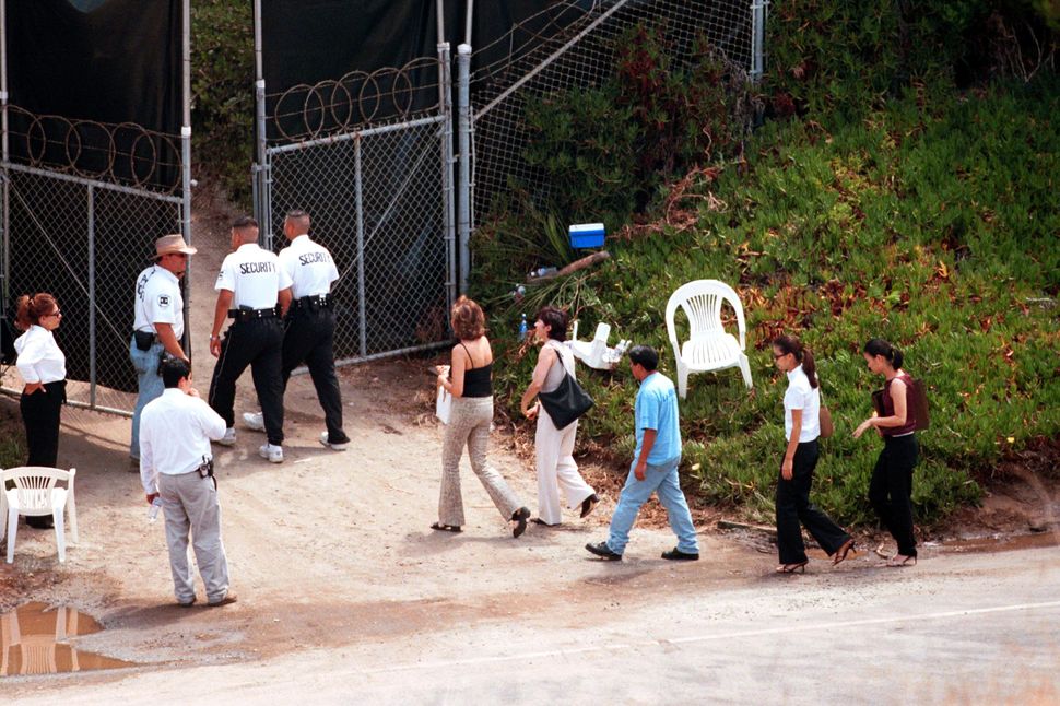 Guests are escorted by security into the wedding of Brad Pitt and Jennifer Aniston in Malibu, CA