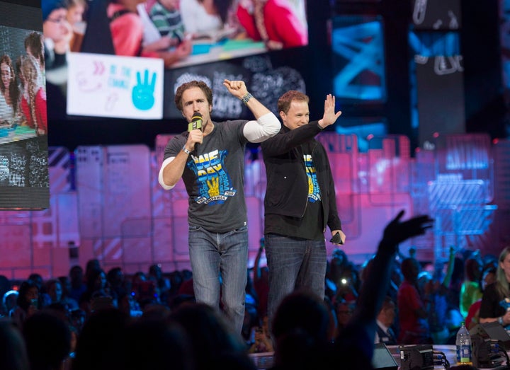 Craig Kielburger and Marc Kielburger speak during "We Day" in Toronto on Oct. 2, 2014.