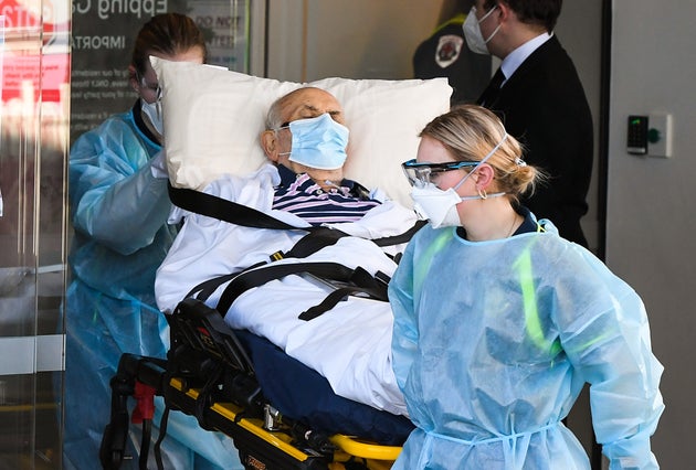 Ambulance officers transport a resident from the Epping Gardens aged care facility in the Melbourne suburb of Epping on July 29, 2020, as the city battles fresh outbreaks of the COVID-19 coronavirus.