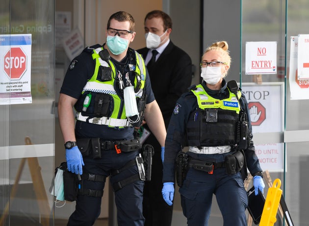 Police leave the Epping Gardens aged care facility in the Melbourne suburb of Epping on July 29, 2020, as the city battles fresh outbreaks of the COVID-19 coronavirus.