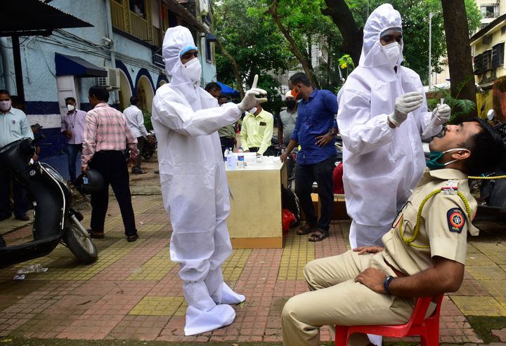BMC medical staff conducts the antigen test of a Mumbai Police personnel posted at Mahim Police Station on July 25, 2020 in Mumbai.