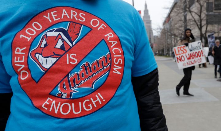 A man wears a shirt calling on Cleveland's baseball franchise to change its logo and name at a 2018 protest outside the team's stadium.