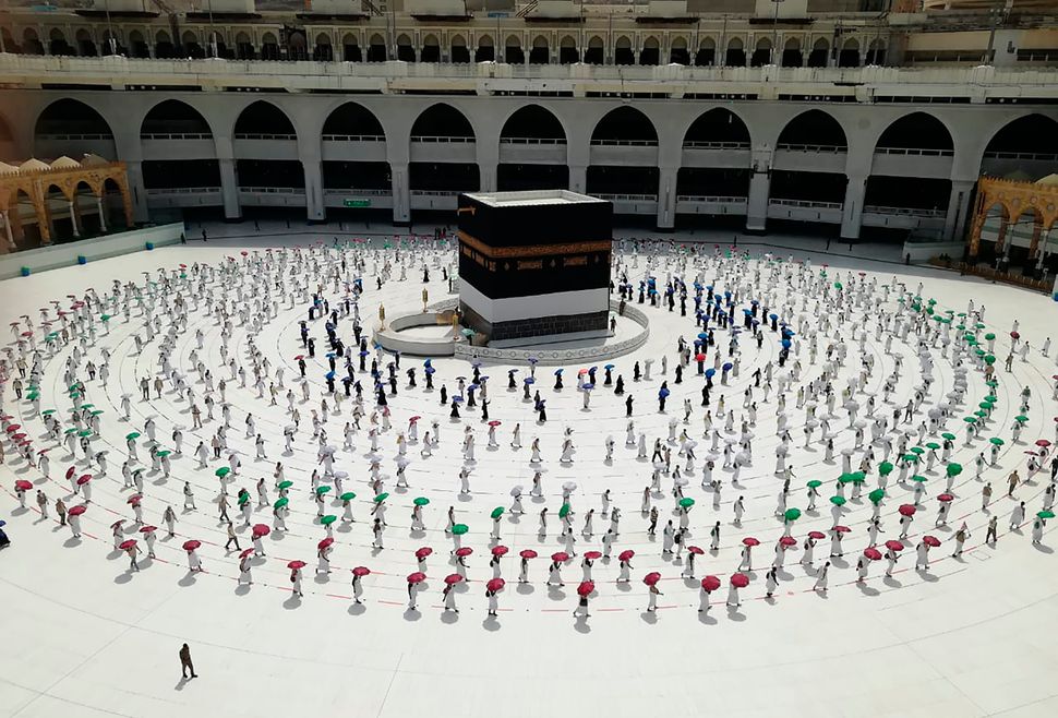 Muslim pilgrims circle the Kaaba at the Grand Mosque, as they observe social distancing to protect themselves against the coronavirus.
