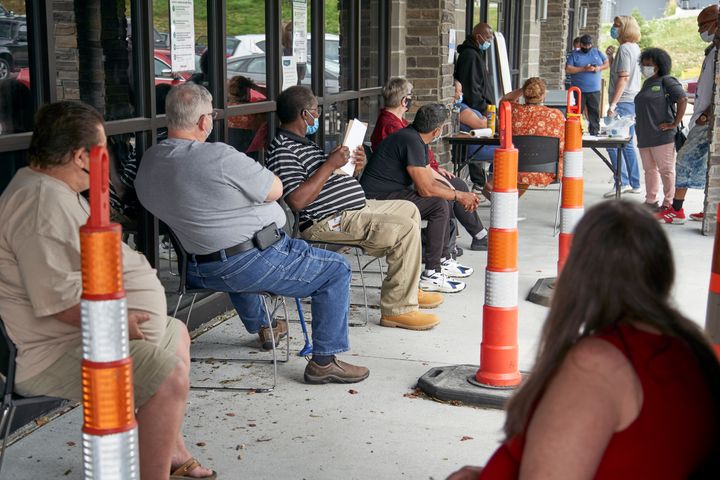 Job seekers exercise social distancing as they wait to be called into the Heartland Workforce Solutions office in Omaha, Neb., on July 15.