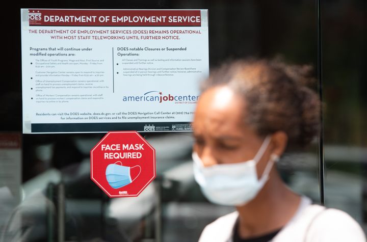 Diana Yitbarek, 44, leaves the DC Department of Employment Services, after trying to find out about her unemployment benefits in Washington, DC, on July 16. The U.S. economy shrank at a 33% annual rate in the April-June quarter, it was reported Thursday. 