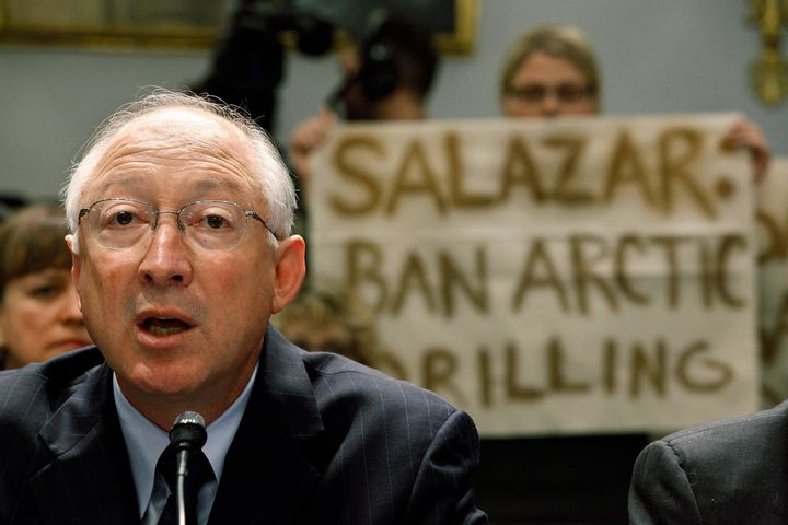Greenpeace demonstrators hold up signs behind Interior Secretary Ken Salazar as he testifies before the House Committee on Natural Resources in May 2010, five weeks after the BP Deepwater Horizon rig explosion and oil spill.