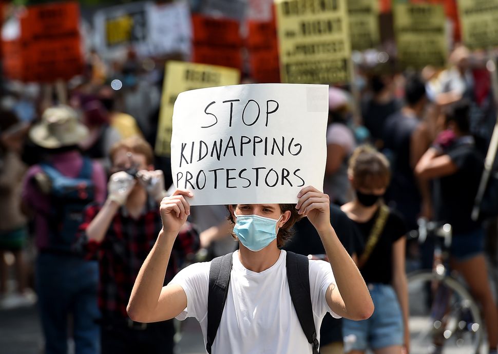 Demonstrators participate July 25 in a rally against "Trump's Police State" in Washington, D.C.