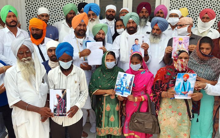 Akal Takht Jathedar Giani Harpreet Singh, Punjabi Ekta Party (PEP) president Sukhpal Singh Khaira and families of those booked under UAPA hold photographs of their kins booked outside Golden Temple, on July 27, 2020 in Amritsar.