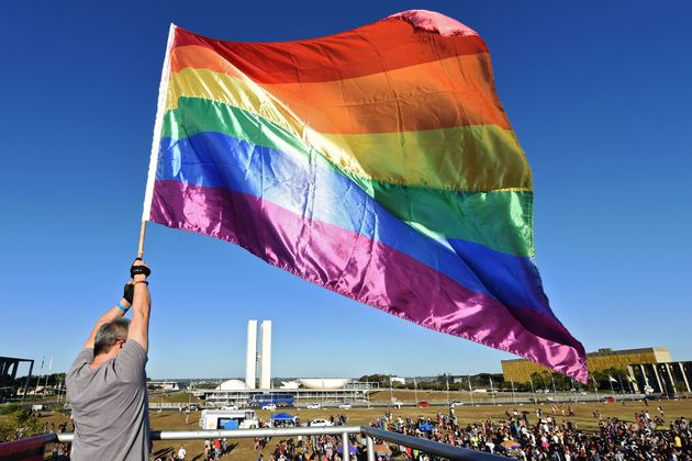 Manifestante agita uma bandeira do arco-íris durante a 22ª Parada do Orgulho LGBT, em 2019,...