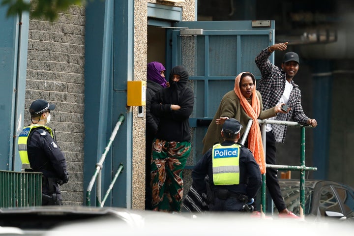 Residents talk with police officers at the Flemington Towers Government Housing complex on July 6 in Melbourne, Australia.