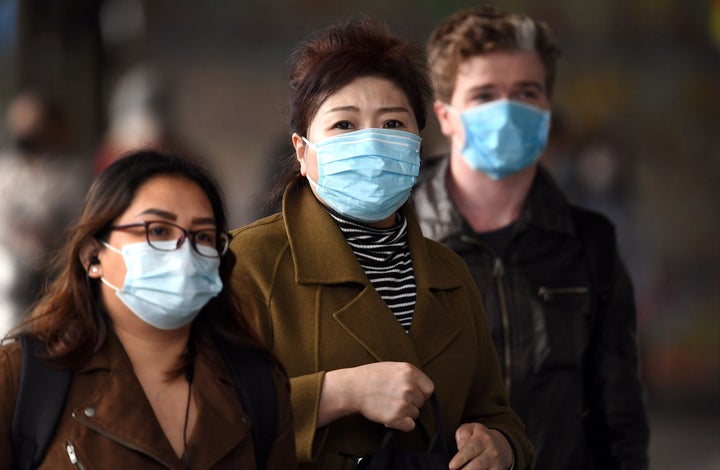 Commuters walk outside Melbourne's Flinders Street Station on July 23, on the first day of the mandatory wearing of face masks in public areas.