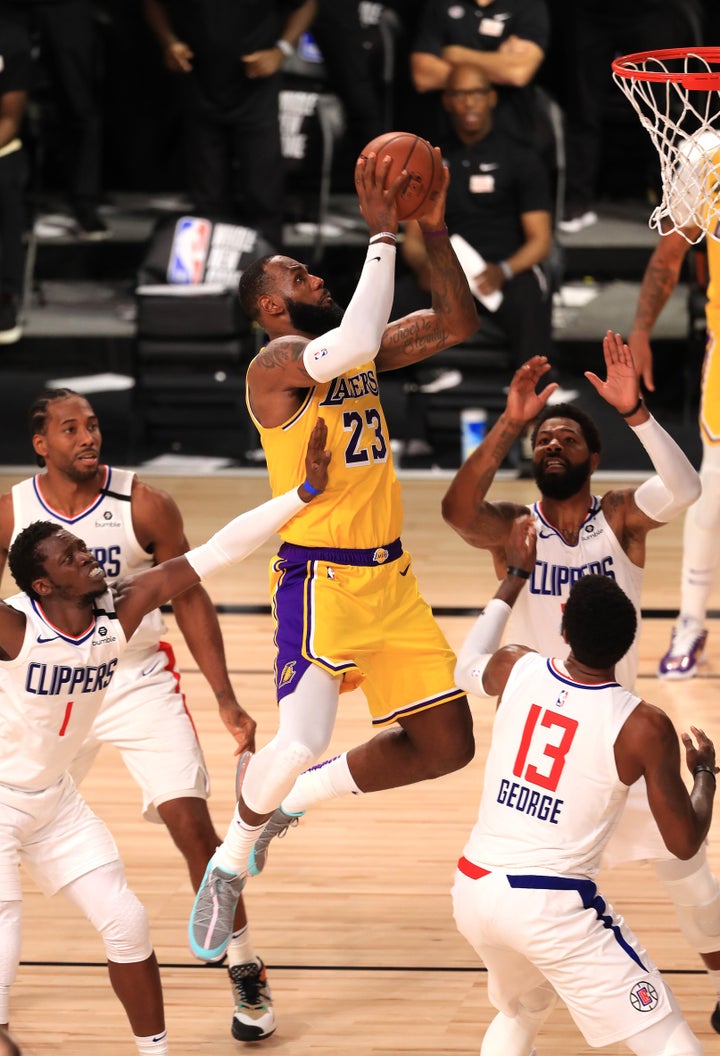 LAKE BUENA VISTA, FLORIDA - JULY 30: LeBron James #23 of the Los Angeles Lakers makes a shot against the LA Clippers during t