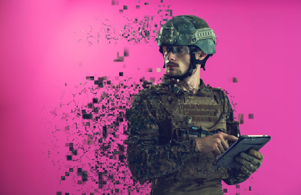 soldier using tablet computer hands closeup pnk background pixelated neural network concept