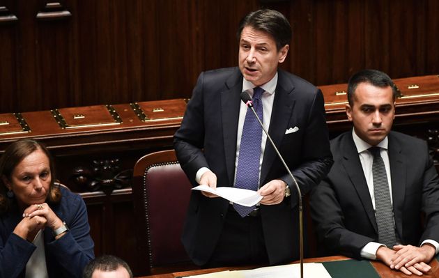 Italy's Prime Minister Giuseppe Conte (C) stands next to Italy's Interior Minister Luciana Lamorgese...