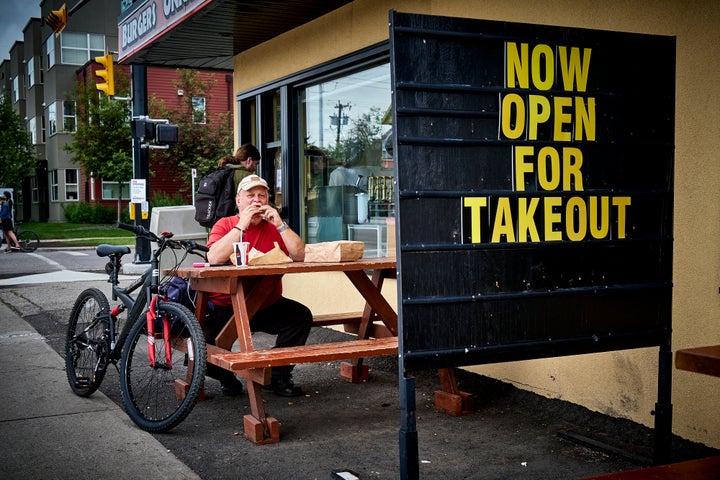 A patron enjoys takeout in Calgary, Alta., on June 23, 2020, amid a worldwide COVID-19 pandemic.