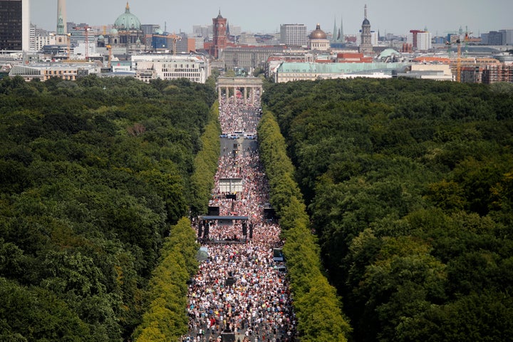 People gather at the Brandenburg gate for a demonstration against coronavirus restrictions in Berlin, Germany, Saturday, Aug. 1, 2020.