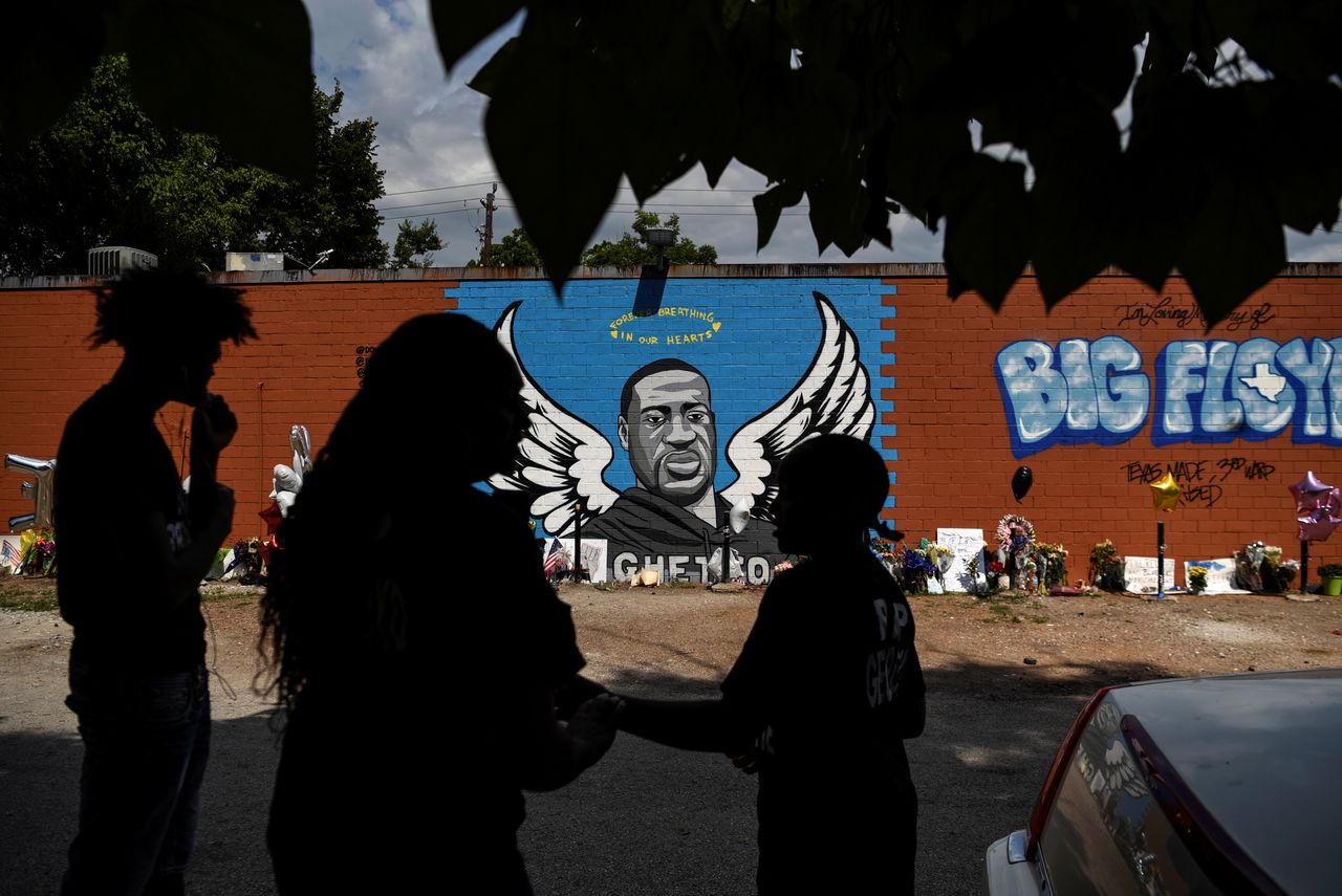 Mourners photograph a mural of George Floyd, whose death in Minneapolis police custody sparked nationwide protests against racial inequality, in Houston on June 8.