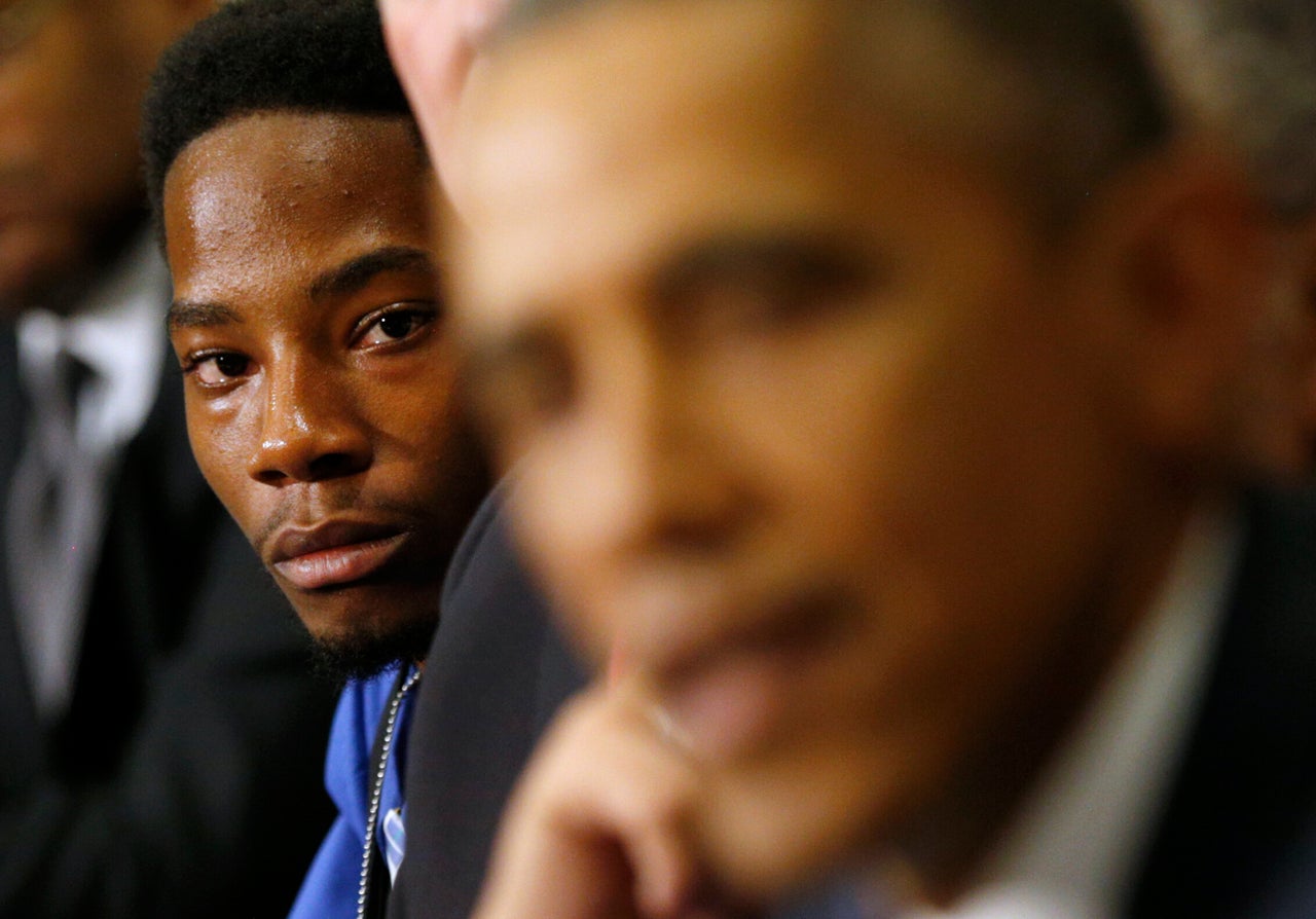 Youth leader Rasheen Aldridge of the Ferguson Commission listens as President Barack Obama speaks at the White House on Dec. 1, 2014.