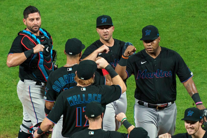 FILE - In this Friday, July 24, 2020, file photo, Miami Marlins' Jesus Aguilar, right, celebrates a 5-2 win with teammates following a baseball game against the Philadelphia Phillies in Philadelphia. (AP Photo/Chris Szagola, File)