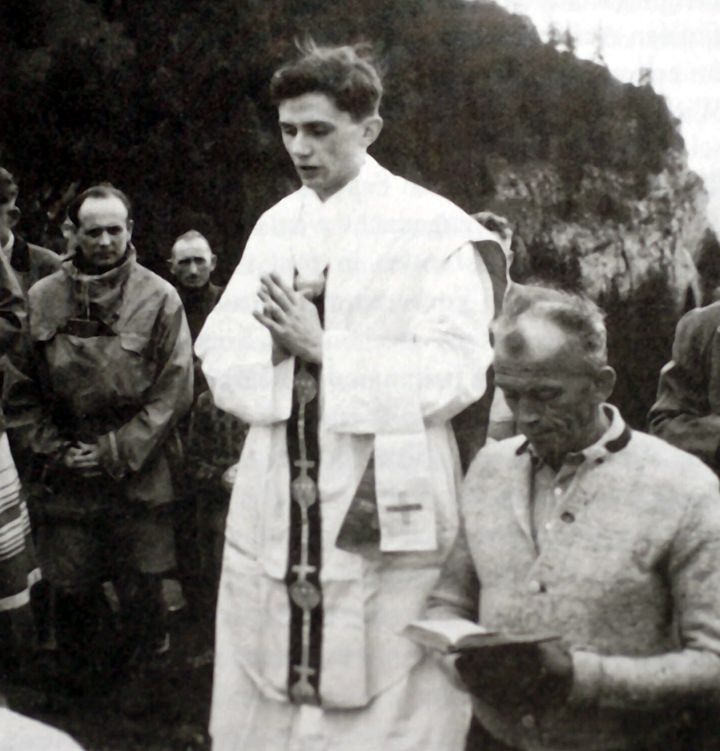 A photo taken during the summer of 1952 near Ruhpolding shows Joseph Ratzinger (center) praying during an open-air mass.
