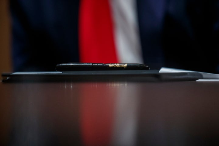 A pen to be used by President Donald Trump rests upon an executive order during a meeting with U.S. tech workers Monday at the White House. Trump later signed the order to prioritize hiring American workers during the economic crisis.