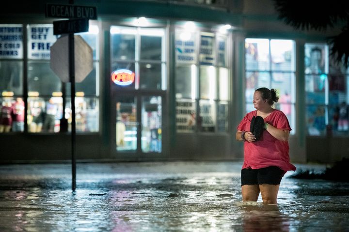 A woman walks through floodwaters on Ocean Boulevard in Myrtle Beach, South Carolina on Monday.