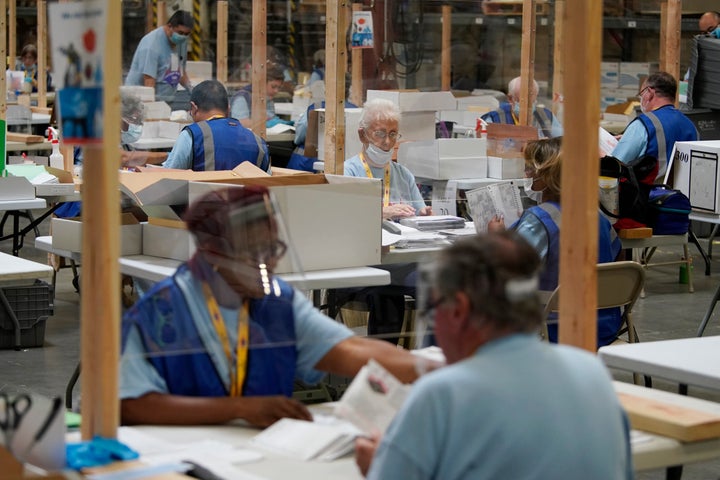 Election workers process mail-in ballots during a nearly all-mail primary election on June 9, 2020, in Las Vegas. 