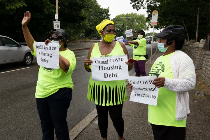 Annie Gordon, left, Gabrielle Rene, center, and Jenny Clark, right, rally for protection from evictions on June 27, 2020, in