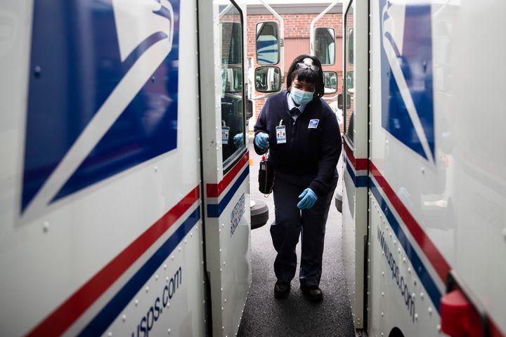 In this Wednesday, May 6, 2020, photo, United States Postal Service carrier Henrietta Dixon gets into her truck to deliver ma