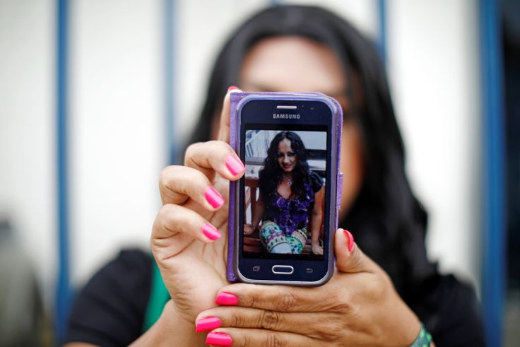 A friend in El Salvador shows a picture of Camila Diaz Cordova, a trans woman killed in that country where she returned after being denied asylum in the U.S.