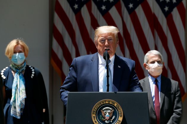 President Donald Trump speaks about the coronavirus in the Rose Garden of the White House, Friday, May 15, 2020, in Washington. Dr. Anthony Fauci, director of the National Institute of Allergy and Infectious Diseases, right, and White House coronavirus response coordinator Dr. Deborah Birx listen