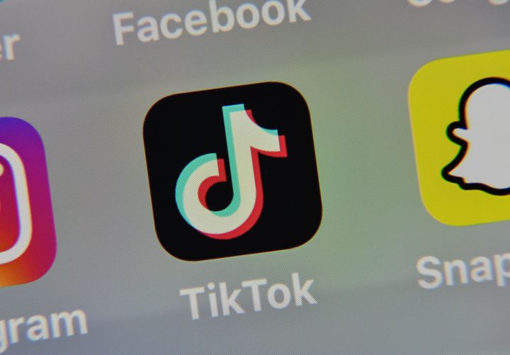 The TikTok logo appears next to other social media applications on a tablet in France on May 5, 2020. On Monday, Microsoft said it was in talks to buy parts of TikTok.