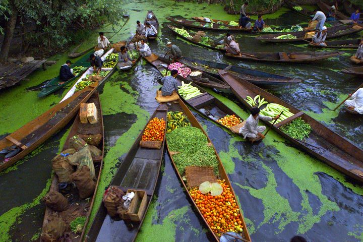 Kashmiri vegetable sellers gather at a floating market on Dal Lake in Srinagar, the summer capital of Jammu and Kashmir state in August 11, 2002. 