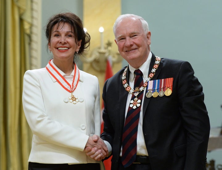 Louise Otis of Montreal, Que., gets invested as an Officer of the Order of Canada by former governor general David Johnston during a ceremony at Rideau Hall in Ottawa on Feb. 12, 2016. 