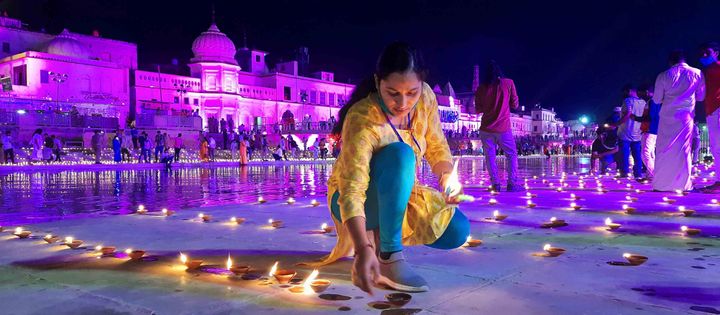 A woman in Ayodhya lights lamps on the eve of the Ram Mandir 'Bhoomi Pujan' on August 4, 2020. 