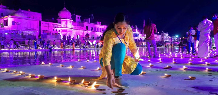 A woman in Ayodhya lights lamps on the eve of the Ram Mandir 'Bhoomi Pujan' on August 4, 2020.