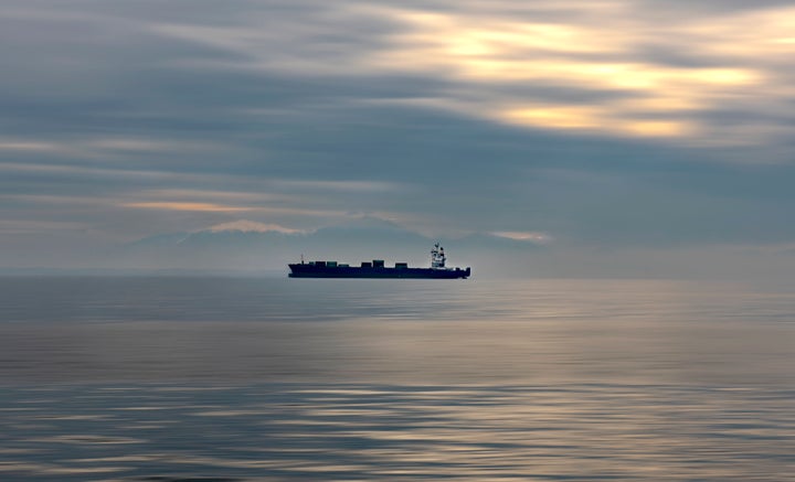 Container ship traveling on Aegean sea. Greece.