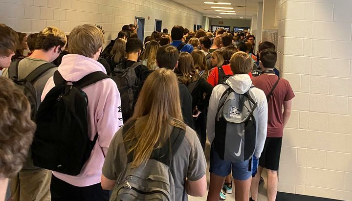 A photo taken Aug. 4, 2020, by a student at North Paulding High School in Dallas, Georgia, shows students crowding hallways while fewer than half wear masks.