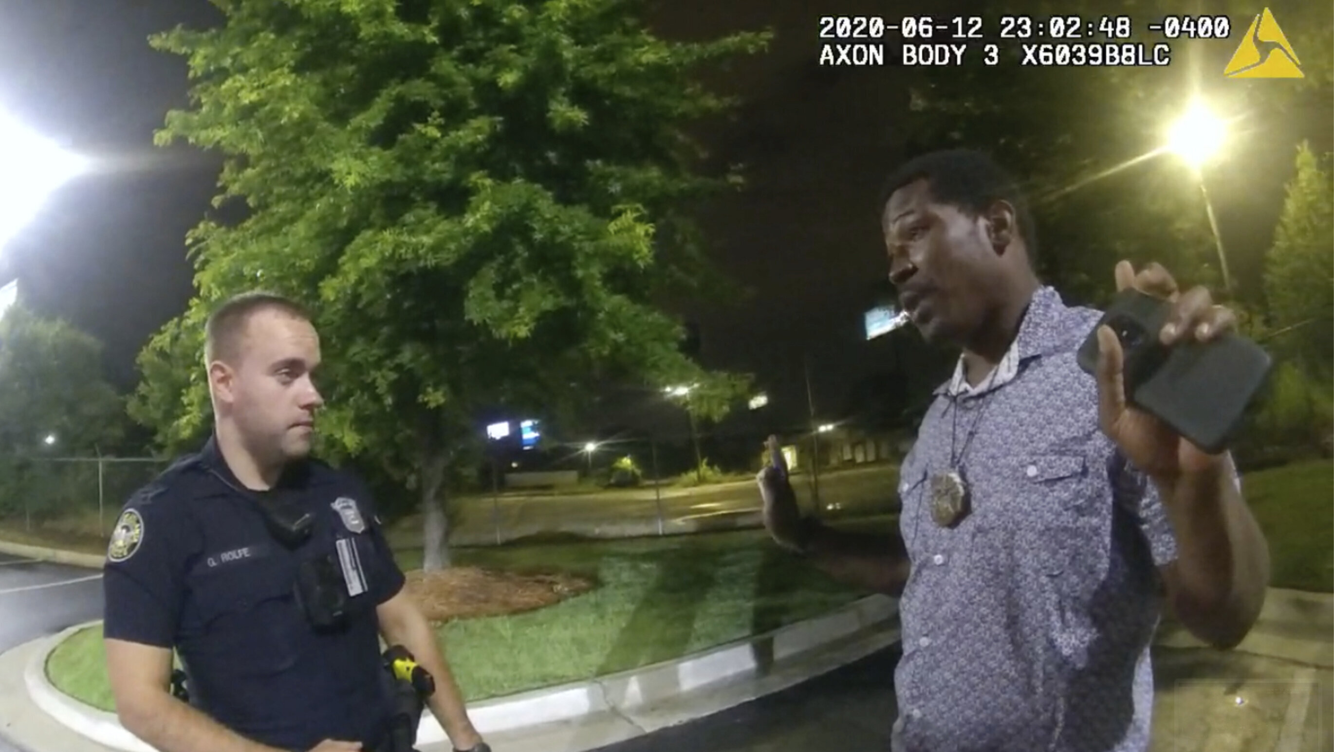 Rayshard Brooks (right) being questioned by Garrett Rolfe (right) outside of a Wendy's in Atlanta on June 12. Shortly thereafter, he was fatally shot twice in the back while running away, authorities said.