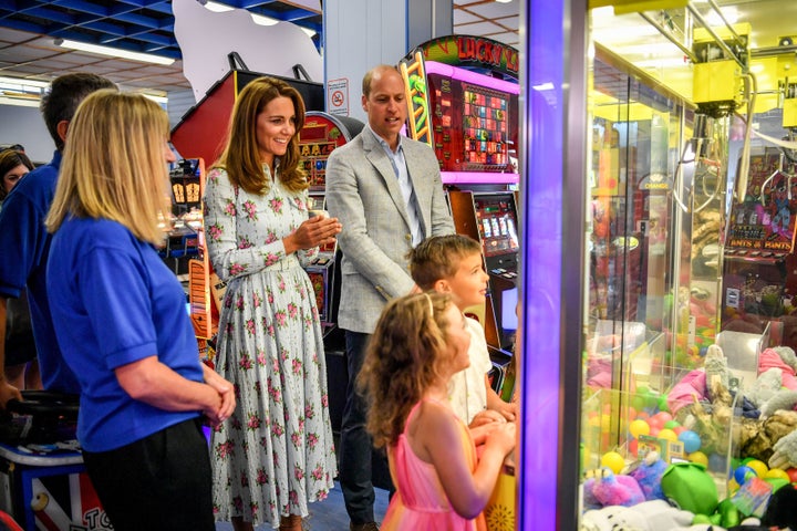 Kate and William watch children play a grab a teddy game at Island Leisure Amusement Arcade during their visit to Barry Island, South Wales. 