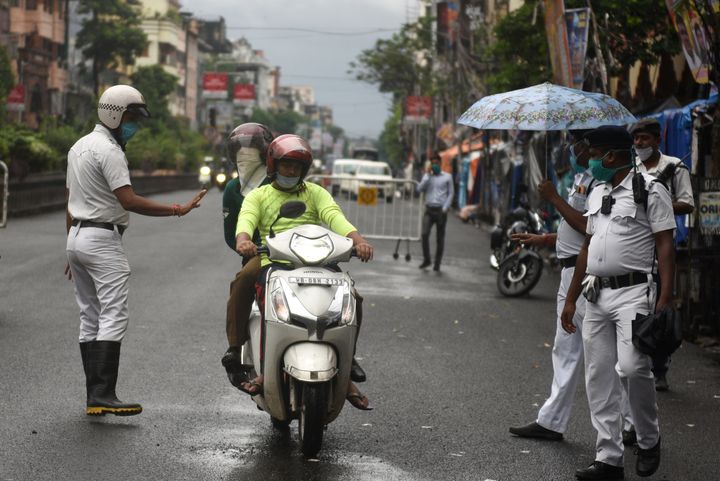 Kolkata police screen commuters at Central Avenue during a lockdown in the state to curb Covid-19 on August 5, 2020 in Kolkata, India.