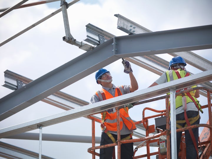 Construction workers in cherry picker