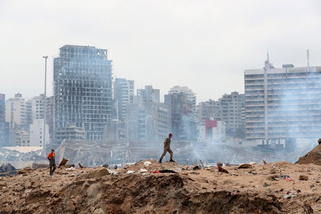 A soldier walks at the devastated site of the explosion in the port of Beirut, Lebanon, Thursday Aug.6,...